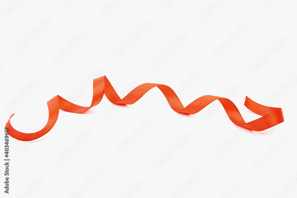 Red satin ribbon curling on a white background Red satin ribbon curling on a white background