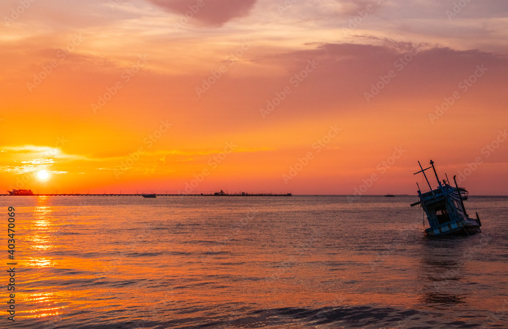 an old ship during the sunset on the sea in the Gulf of Thailand