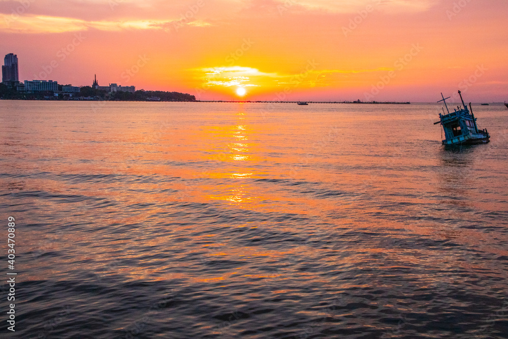 an old ship during the sunset on the sea in the Gulf of Thailand