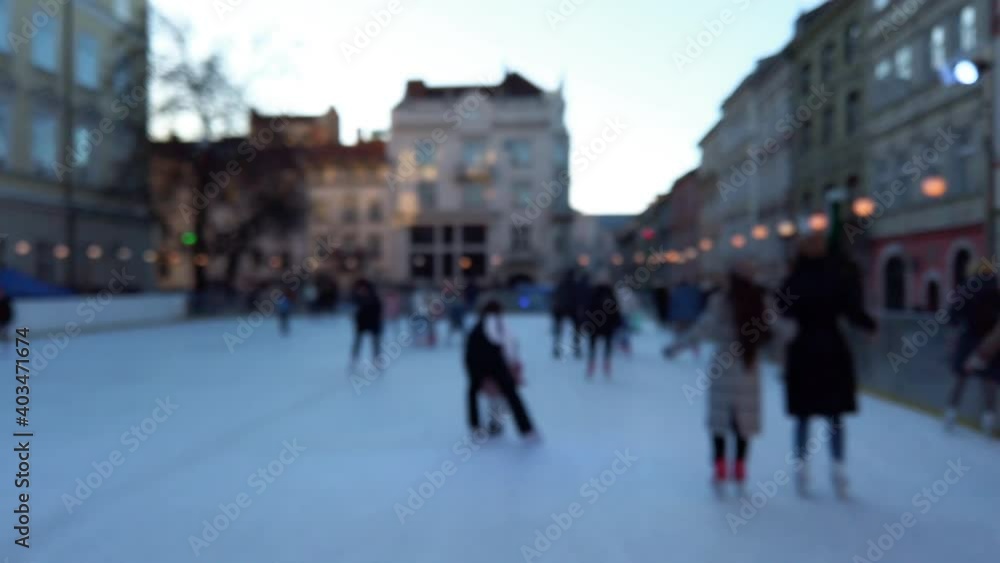People skate on a winter rink. Out of focus. People skate on a winter rink. Out of focus.