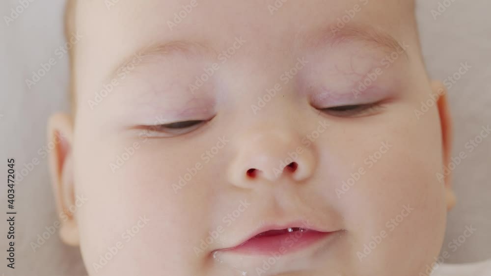 Close up of lovely little baby girl smile. Portrait of infant smile.