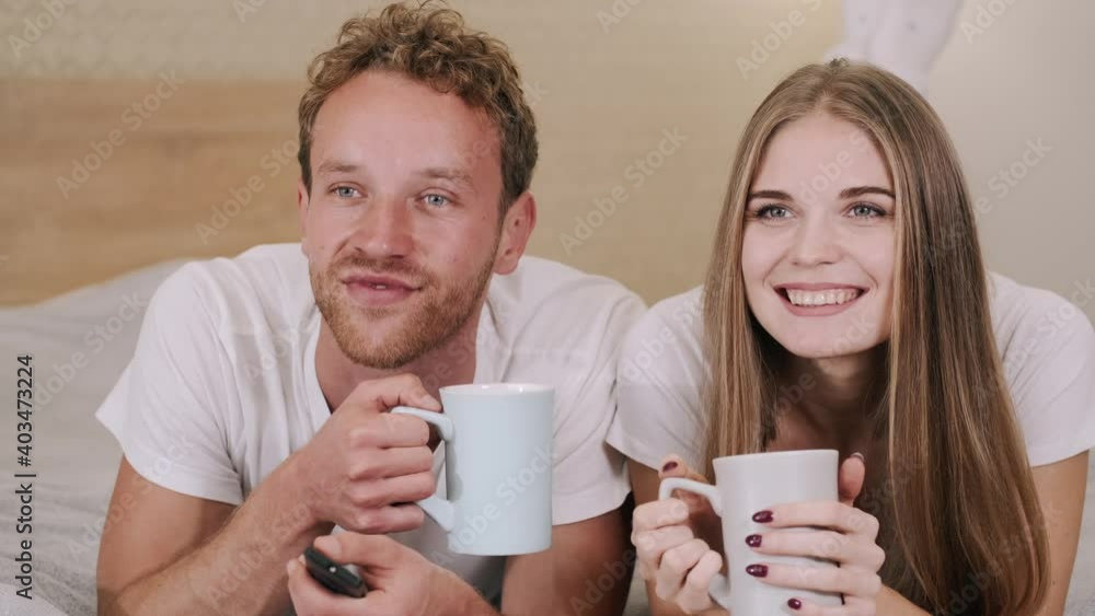 Couple watching tv at home. Front view. Couple watching tv at home. Front view.