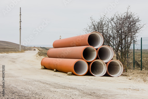 Wallpaper Mural Large diameter water pipes are located at the edge of the road. Torontodigital.ca