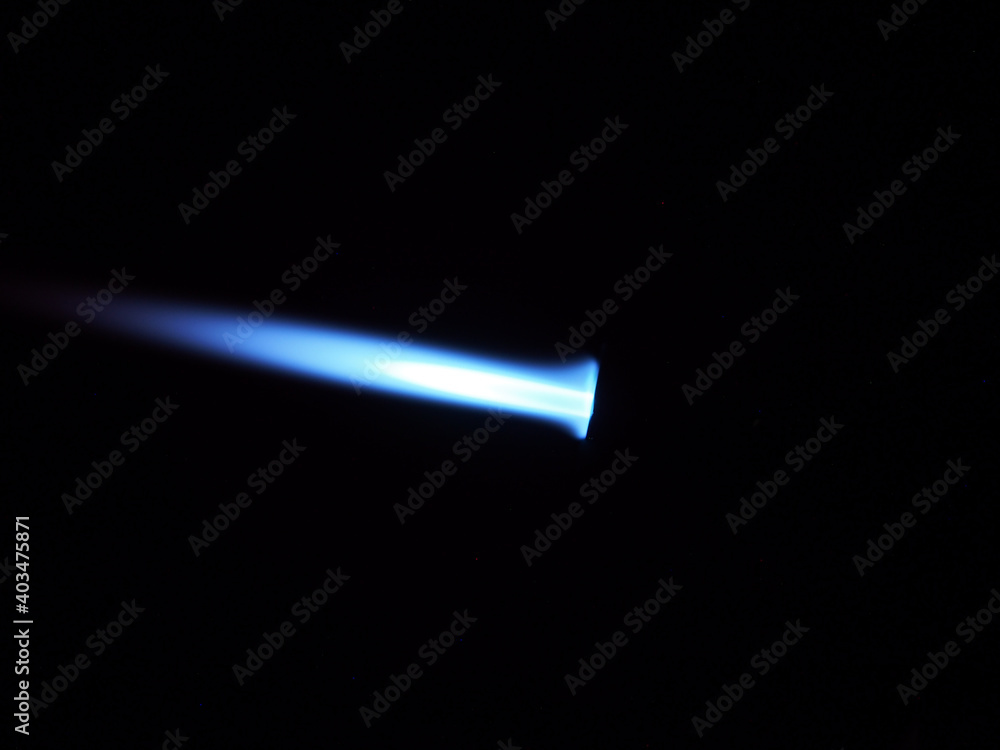 The glow of a gas lighter torch in the dark. The glow of a gas lighter torch in the dark.