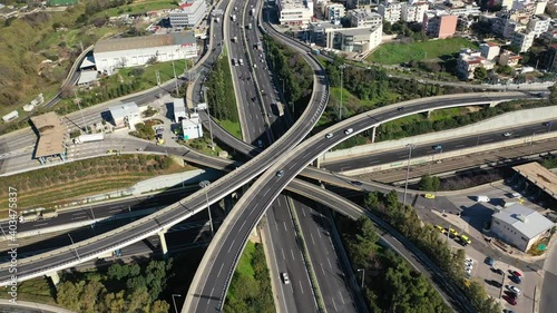 Aerial drone top down time-lapse video of motorway multilevel junction crossing through national road during rush hour, Attica, Athens, Greece. photo