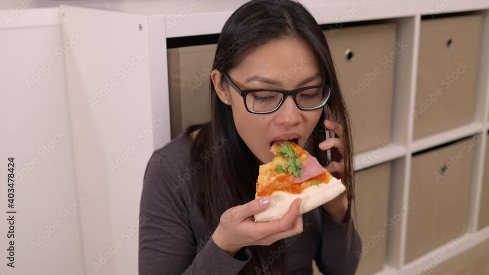 Young woman takes a phone call while eating pizza - videoclip Young woman takes a phone call while eating pizza - videoclip