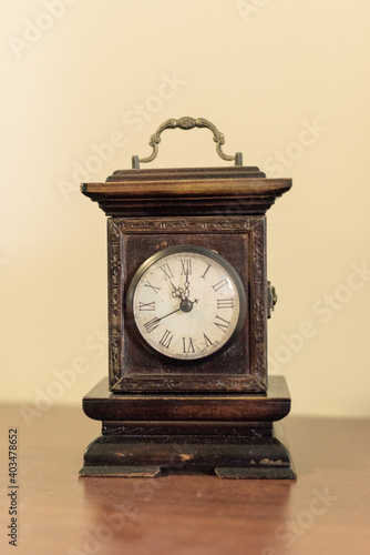 Beautiful old wooden clock on wooden table marking the hours