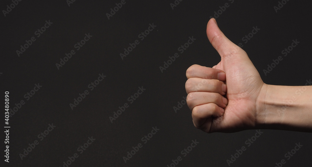 Like sign or thumbs up human hand sign isolated on black background.copy space Like sign or thumbs up human hand sign isolated on black background.copy space