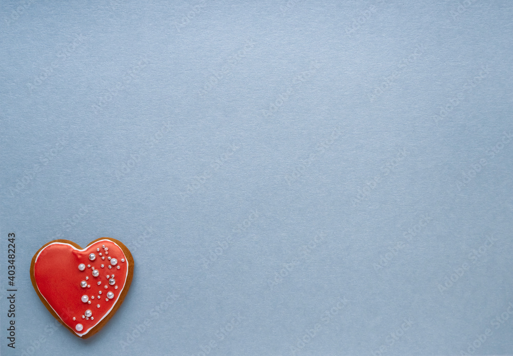 Valentine's day card. Top view on red gingerbread in shape of heart on blue background. Love concept, birthday present, mother day. Top view with copy space for text. Valentine's day card. Top view on red gingerbread in shape of heart on blue background. Love concept, birthday present, mother day. Top view with copy space for text.