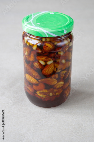 Nuts in honey in a glass jar