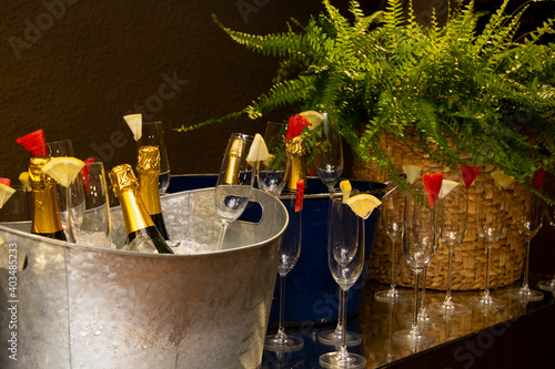Bottles of sparkling wine in a bucket with ice to be served.