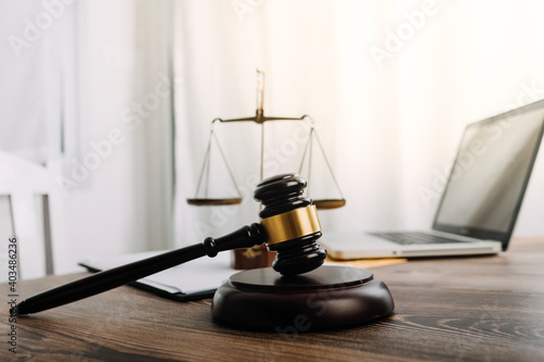 Business and lawyers discussing contract papers with brass scale on desk in office. Law, legal services, advice, justice and law concept picture with film grain effect