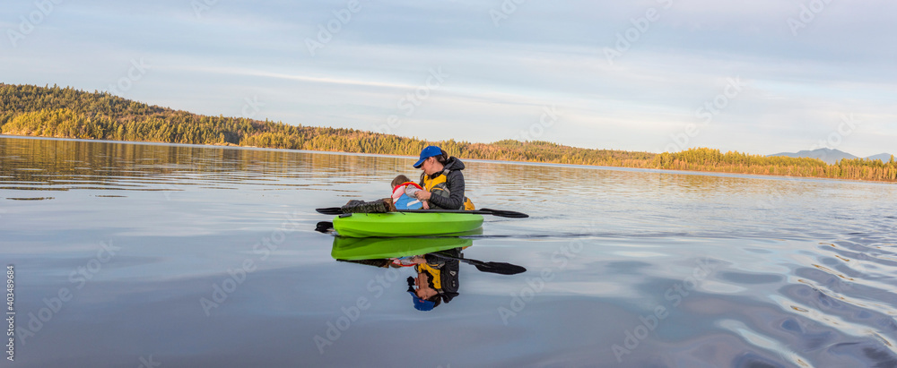 A mother and baby enjoying the open waters whilst inisde of a kayak A mother and baby enjoying the open waters whilst inisde of a kayak