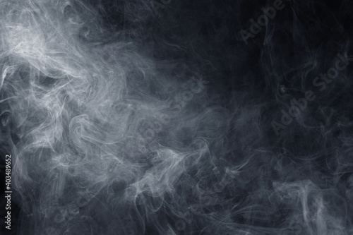 Abstract white smoke moves on black background. Swirling smoke.