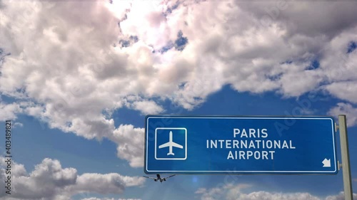 Jet plane landing in Paris CDG, France. City arrival with airport direction sign. Travel, business, tourism and transport concept.