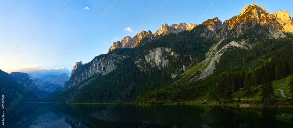 Gosausee lake landscape with Dachstein mountains, forest and Sunrise in Austrian Alps