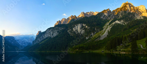 Gosausee lake landscape with Dachstein mountains, forest and Sunrise in Austrian Alps