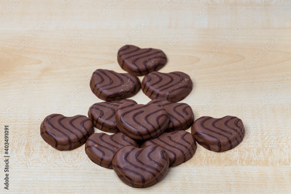 Close up view of chocolate cookies in heart shape on wooden background. Valentines day concept. Close up view of chocolate cookies in heart shape on wooden background. Valentines day concept.