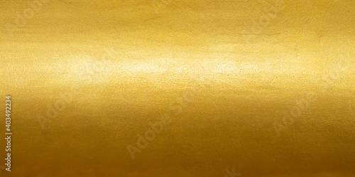 Gold texture background with yellow foil luxury shiny shine glitter sparkle of bright light reflection on golden surface photo