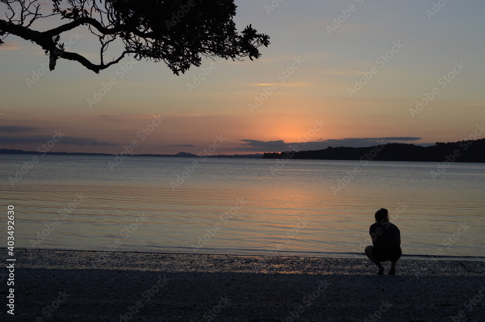 Girl on a beach at sunset
