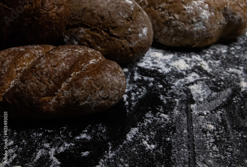 bread and flour on black background  © Maksym