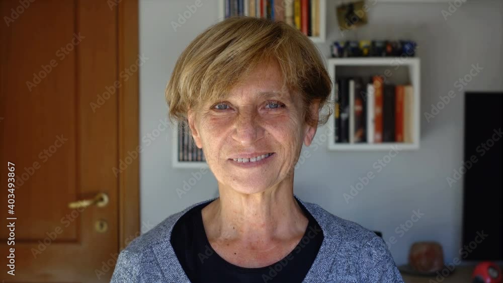 serious pensive woman looks at camera and smiles serious pensive woman looks at camera and smiles