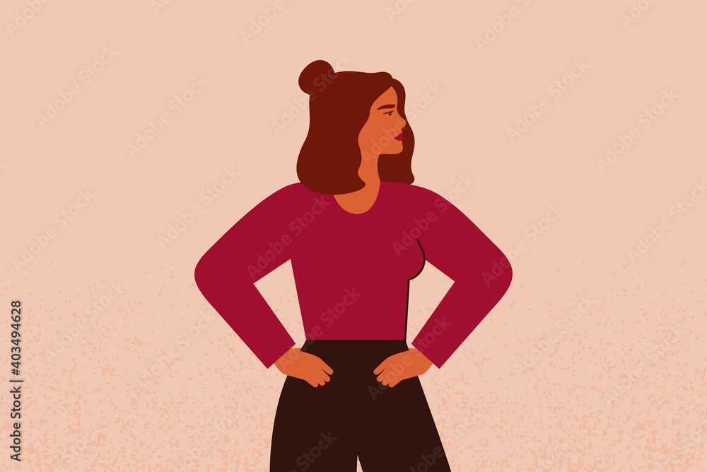 Young strong female with hands on her hips looks forward. Confident Businesswoman or entrepreneur in corporate clothing. The concept of gender equality and of the female empowerment movement. Young strong female with hands on her hips looks forward. Confident Businesswoman or entrepreneur in corporate clothing. The concept of gender equality and of the female empowerment movement.
