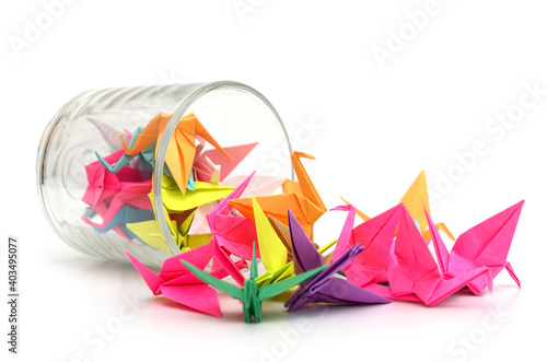 origami paper birds spilling out of glass jar