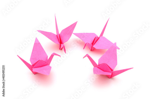 Pink origami birds on white