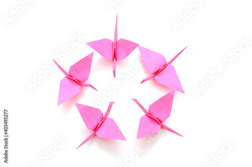 Pink origami birds in circle sign