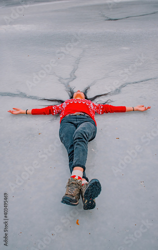 girl with hands up on the frozen water