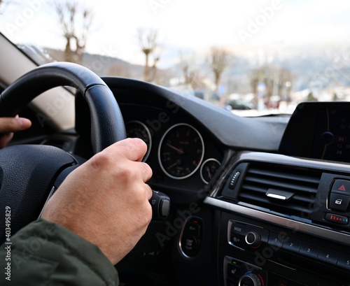 Man driving car. Hands on the steering wheel. 
