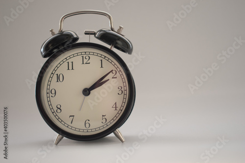 Old vintage alarm clock isolated in white background
