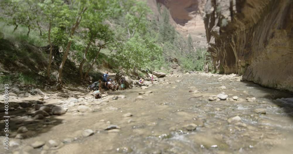 Tourists walking the Narrows path in Zion park Tourists walking the Narrows path in Zion park