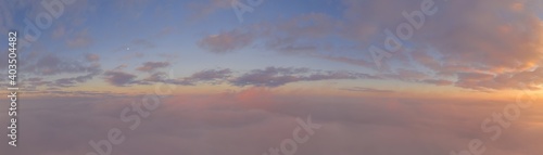 Sunrise panorama in lilac and pale pink shades with cirrus clouds. Sky background. View from the plane during the flight on vacation © yelantsevv