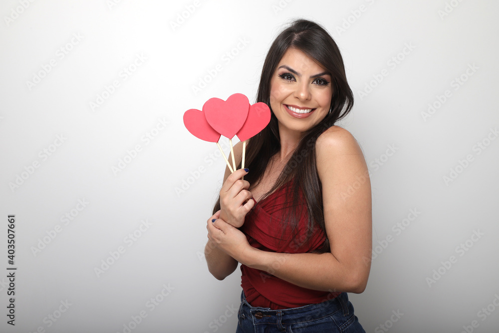 beautiful girl holding valentine's gift on white background