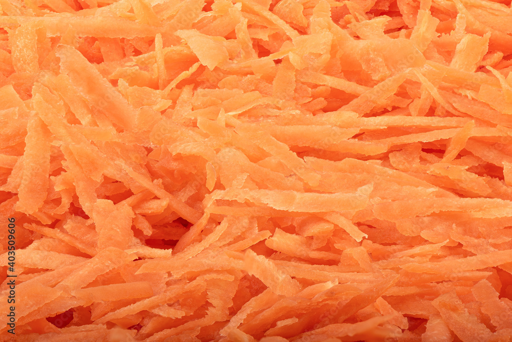 Full frame of a heap of grated carrots. The texture of grated carrots. Food background. Full frame of a heap of grated carrots. The texture of grated carrots. Food background.