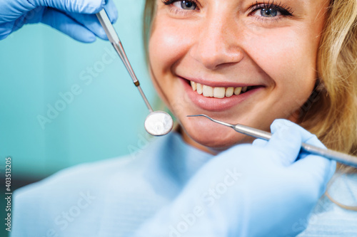 Close-up of the dentist s hands with medical devices. Large detail - dentist s mirror  curling and probe. Resolving dental problems effectively with confident  professional gestures