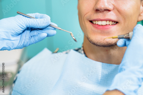 Close-up of the dentist's hands with medical devices. Large detail - dentist's mirror, curling and probe. Resolving dental problems effectively with confident, professional gestures