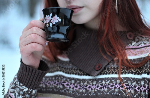 person girl holding a glass of coffee
