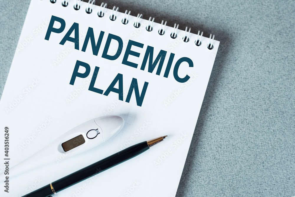 Blank notebook with thermometre and pen on table. PANDEMIC PLAN text. Blank notebook with thermometre and pen on table. PANDEMIC PLAN text.