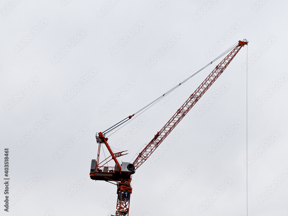 silhouette of a construction crane against a cloudy sky on a high rise building site silhouette of a construction crane against a cloudy sky on a high rise building site