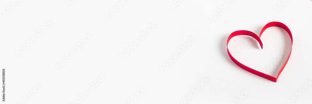 Red heart on a light white background. Composition Valentine's Day. Banner. Flat lay, top view Red heart on a light white background. Composition Valentine's Day. Banner. Flat lay, top view