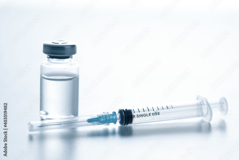 Medical syringe with a needle and a bollte with vaccine. Medical syringe with a needle and a bollte with vaccine.