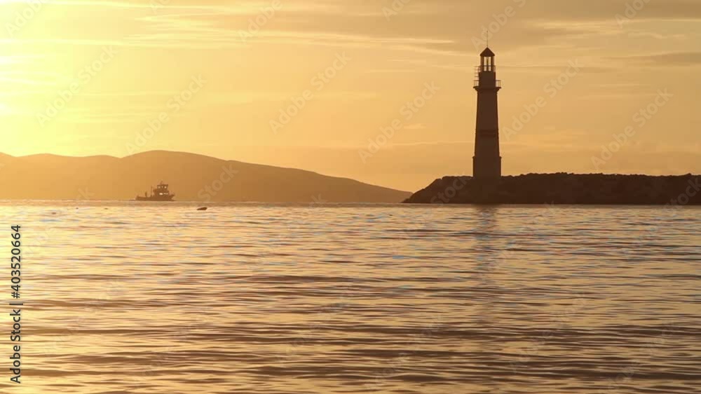 Seascape at sunset. Lighthouse on the coast. Seaside town of Turgutreis and spectacular sunsets Seascape at sunset. Lighthouse on the coast. Seaside town of Turgutreis and spectacular sunsets