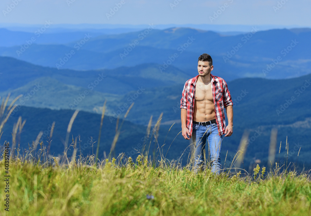 calm walk. travelling adventure. hipster fashion. cowboy in hat outdoor. man on mountain landscape. camping and hiking. countryside concept. farmer on rancho. sexy macho man in checkered shirt