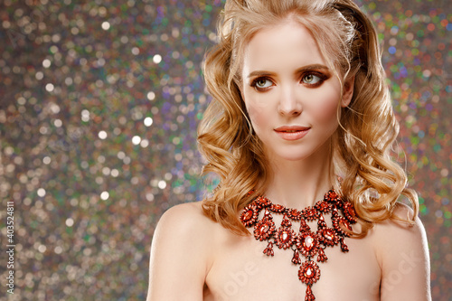 Red jewelry necklace on the neck of a beautiful woman. A gorgeous girl in expensive jewelry.