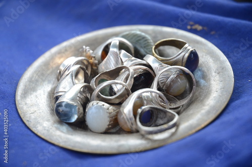 A bowl full of rings in Myanmar market.