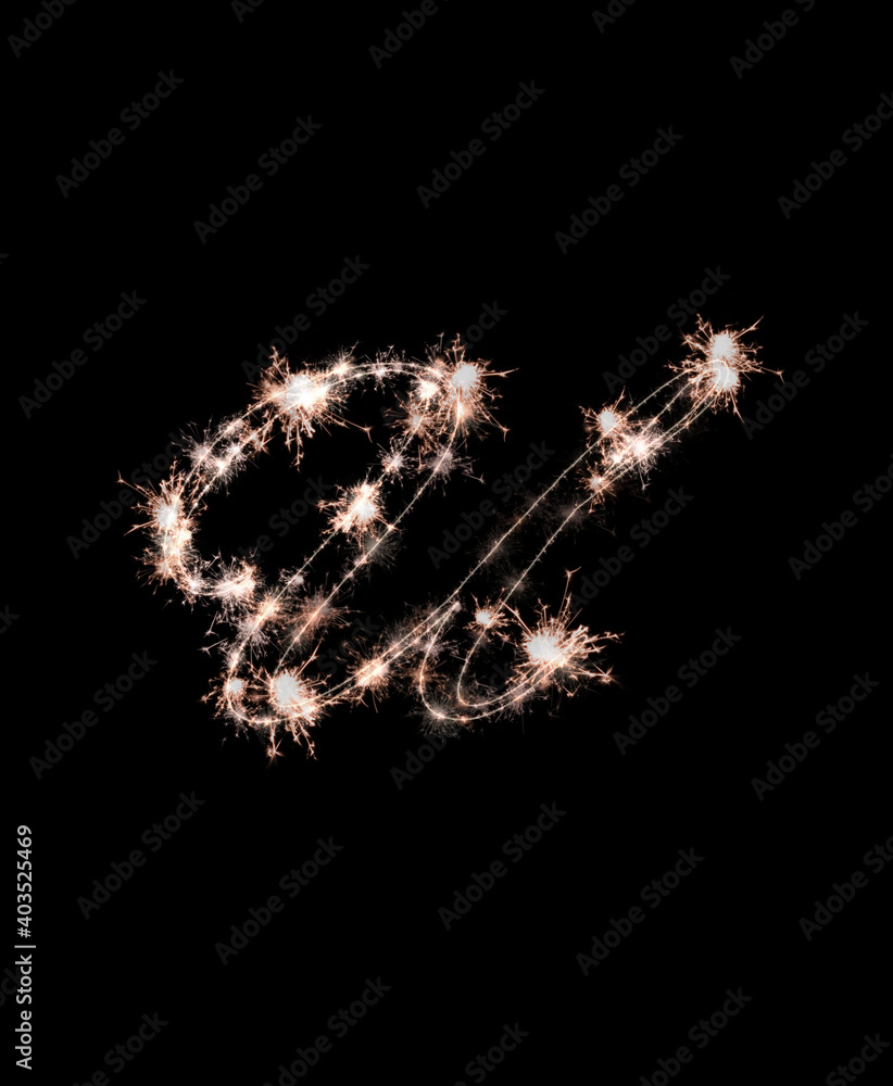 the letter u made from sparks of Bengal lights isolated on a black background.