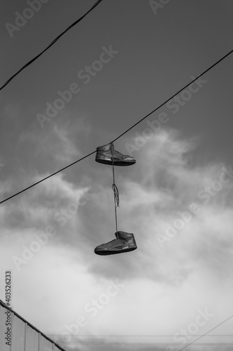 Shoes Hanging from Wire © Carter